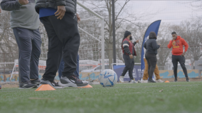 APS PE teachers stand on a field